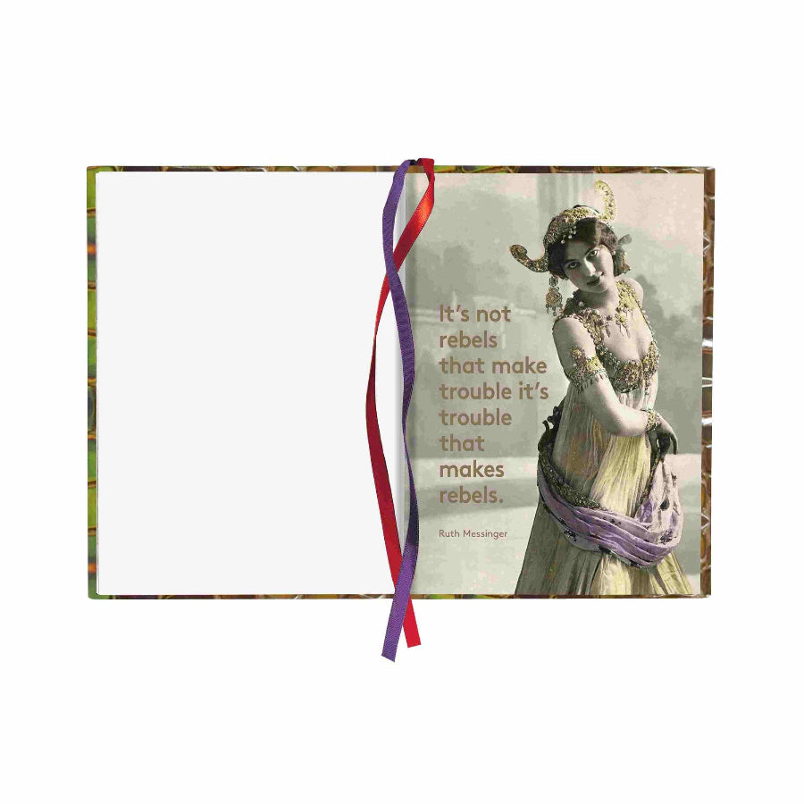 A notebook with a vintage-style cover featuring a woman in an ornate dress and a quote by Ruth Messinger. The notebook is open, showing a blank white page on the left and the printed cover design on the right, with a red and purple ribbon bookmark hanging from the center.
