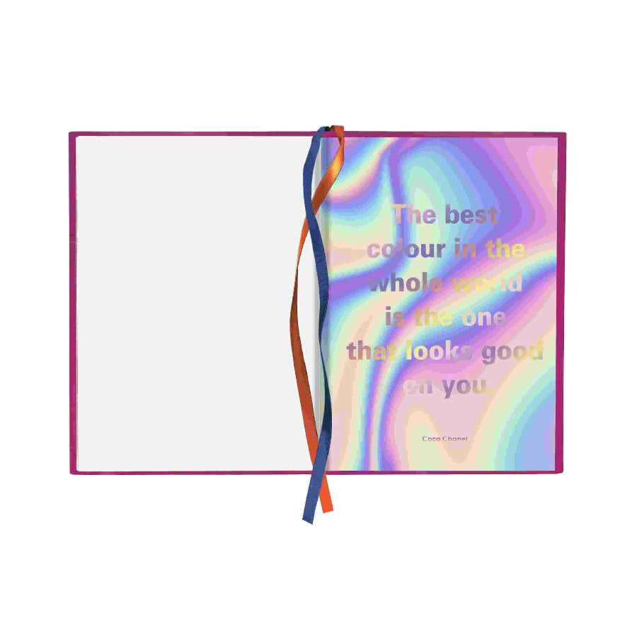 A square notebook or journal with a holographic iridescent cover, shown open on a white background. The right page features a pastel rainbow abstract design with the quote, 'The best colour in the whole world is the one that looks good on you.