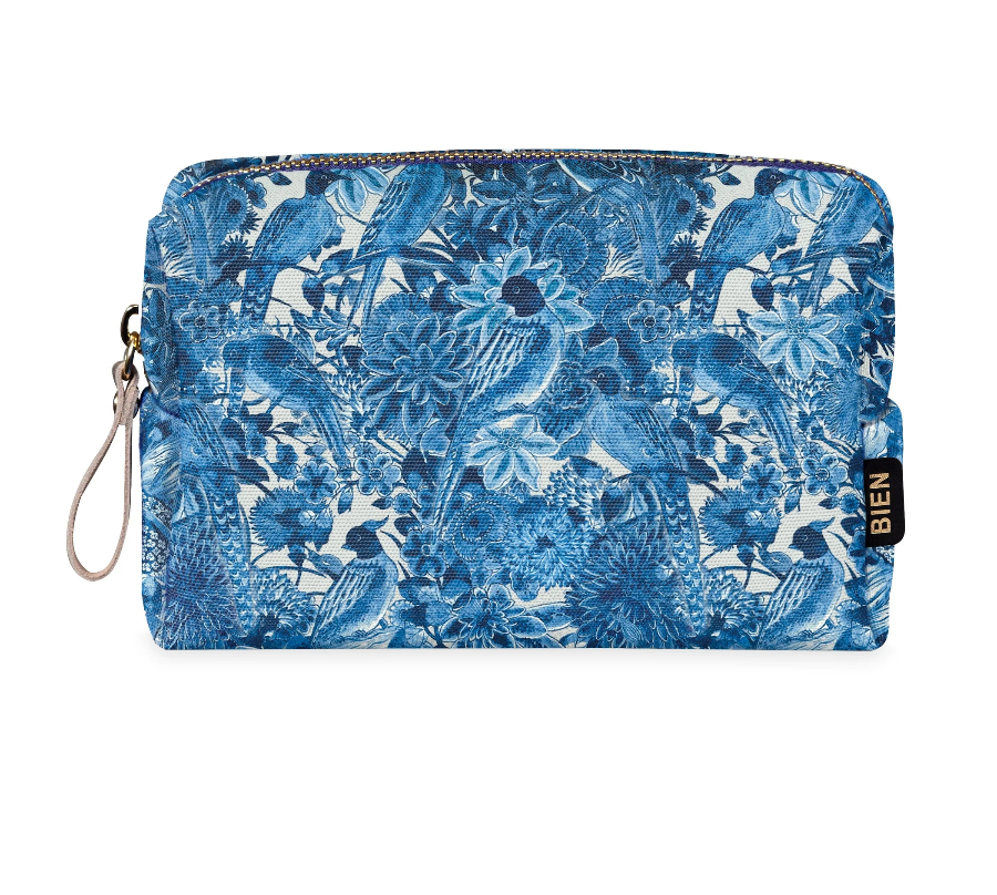 A rectangular zip pouch with a blue and white floral and bird pattern, shown on a white background with a gold 'COMING SOON' banner in the top right corner.