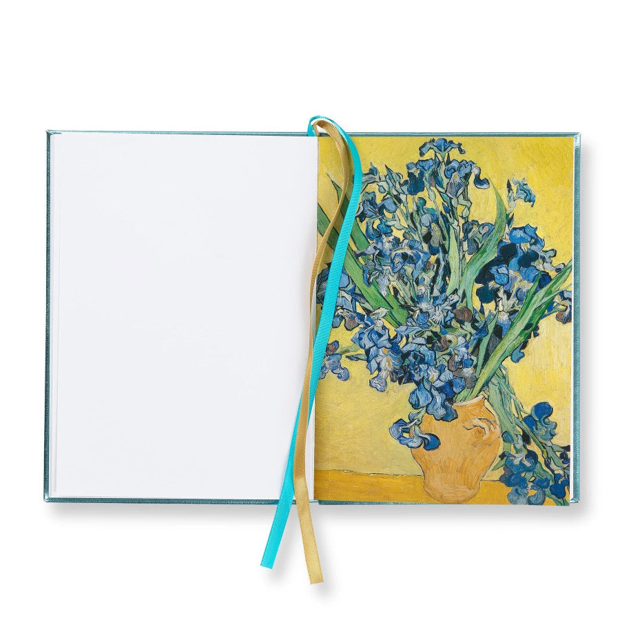 An open notebook or journal with a blank white left page and a right page featuring a painted bouquet of blue flowers in a yellow vase. A turquoise ribbon bookmark and a tan ribbon bookmark hang from the center, set against a plain white background.