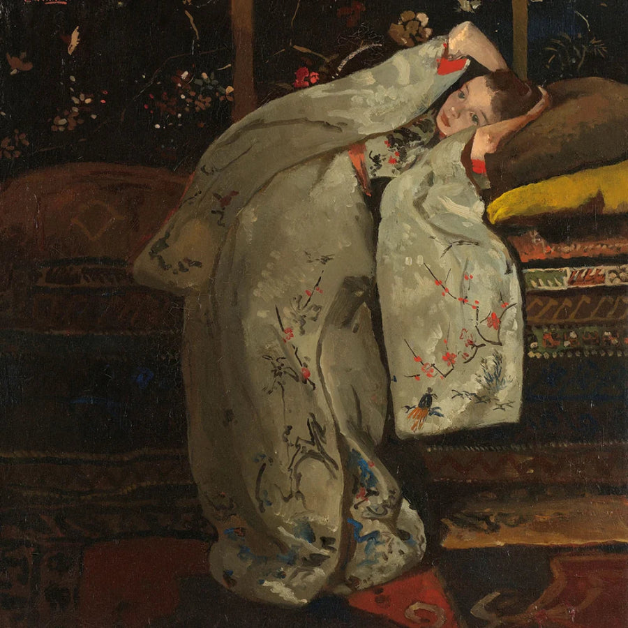 An oil painting depicting a woman in a light gray kimono with red and blue floral motifs, reclining on a dark patterned sofa.