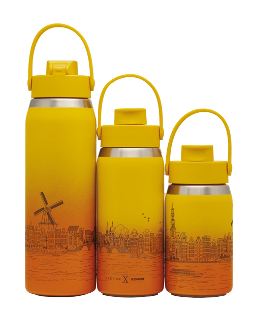 Three Le Creuset vacuum-insulated water bottles in yellow and orange gradient designs with Dutch cityscape illustrations, shown on a white background.