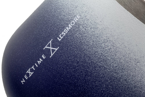 Close-up of a dark blue product with 'Nextime Lessmore' branding.