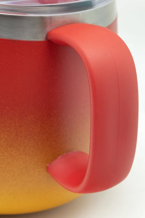 Close-up of a mug with a red handle on a white background