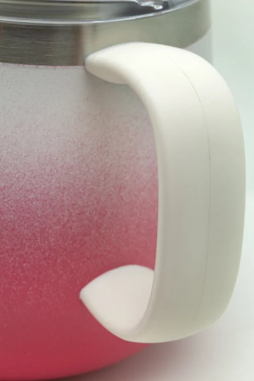 Close-up of a pink mug with a white handle on a light background