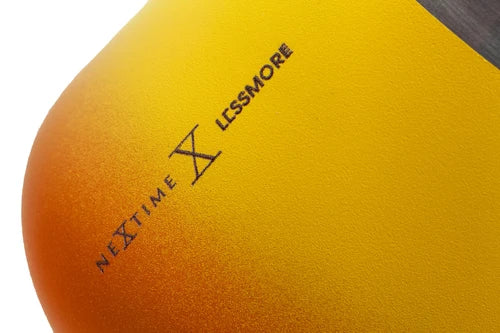 Close-up of a yellow and orange sports ball with 'Nextime X Lessmore' branding.