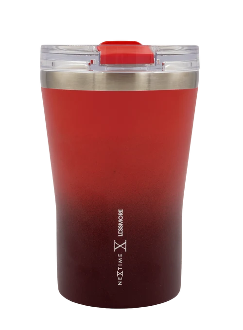 A stainless steel travel tumbler with a red-to-burgundy ombre gradient finish, featuring a clear lid with a red flip-top spout and vertical 'NEXT TIME LESS TIME' branding near the bottom.