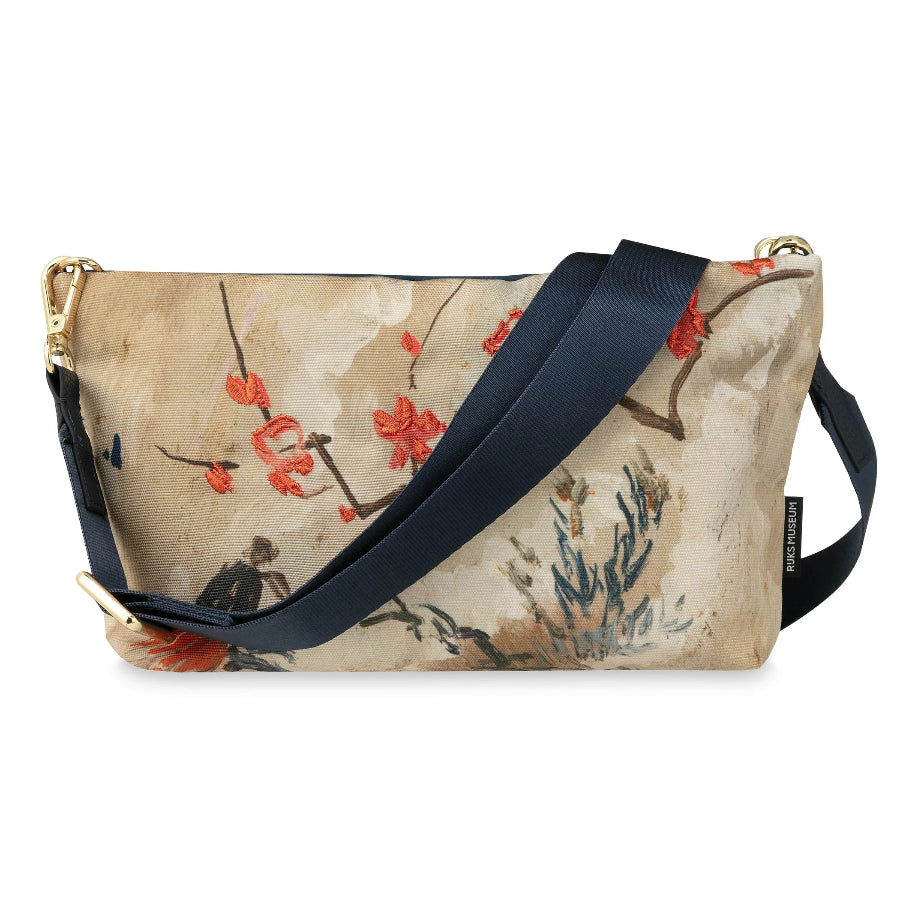 A rectangular shoulder bag with a beige and brown watercolor-style floral print, featuring red blossoms, a navy blue strap, and gold-tone hardware.