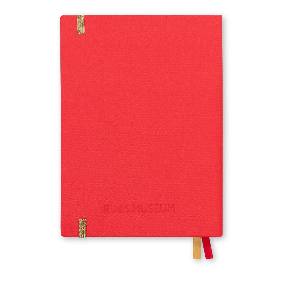 A red hardcover notebook with 'BUKS MUSEUM' embossed on the front cover, featuring two small woven tabs on the left edge and two ribbon bookmarks in red and gold, shown against a plain white background.