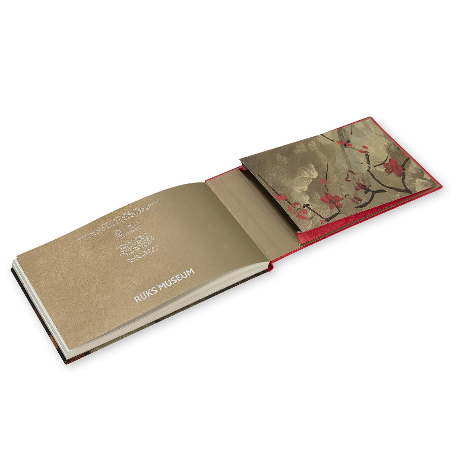 An open hardcover book or art print set on a white background, showing a beige interior page with the text 'RIJKSMUSEUM' and a red-edged page featuring a floral branch illustration.