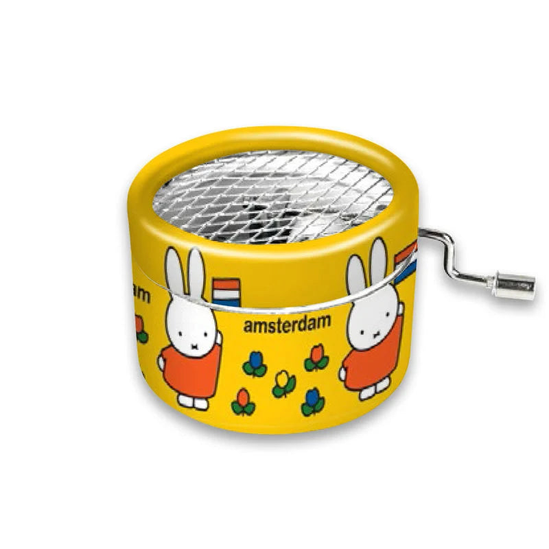 Yellow music box with cartoon characters and 'Amsterdam' text on a white background