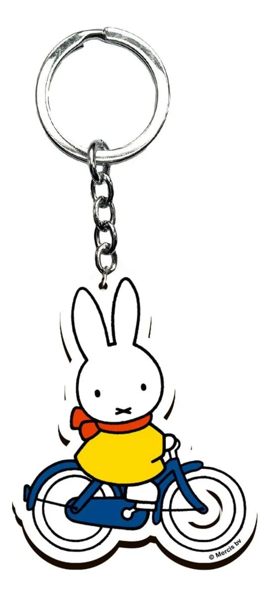 Keychain with a cartoon rabbit character riding a bicycle on a white background