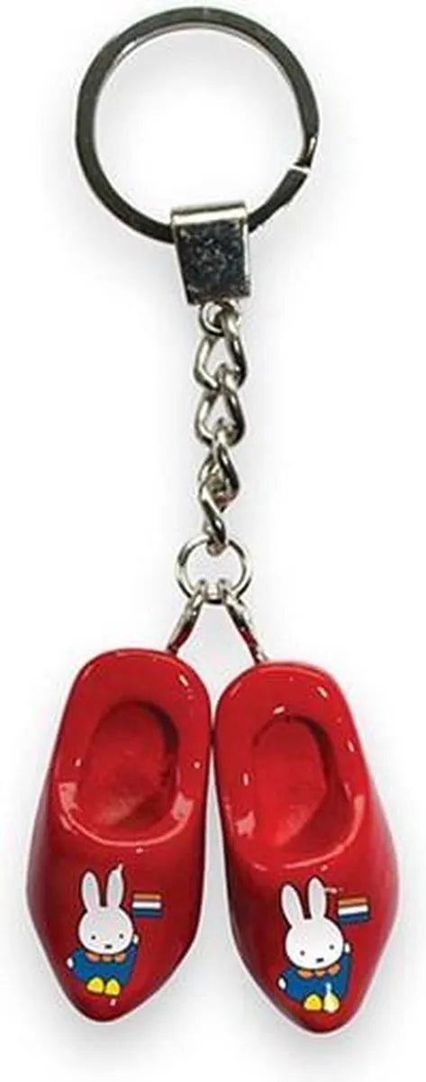 Red wooden shoe keychain with a character design on a white background