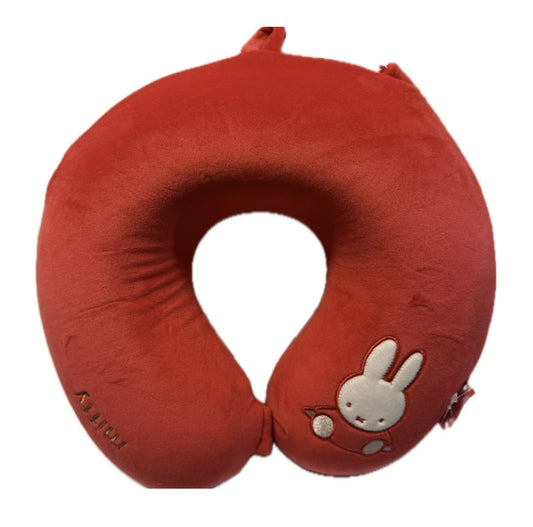 Soft red Miffy travel neck pillow with embroidered details and a removable washable cover. Designed for comfortable travel by plane, train, or car.