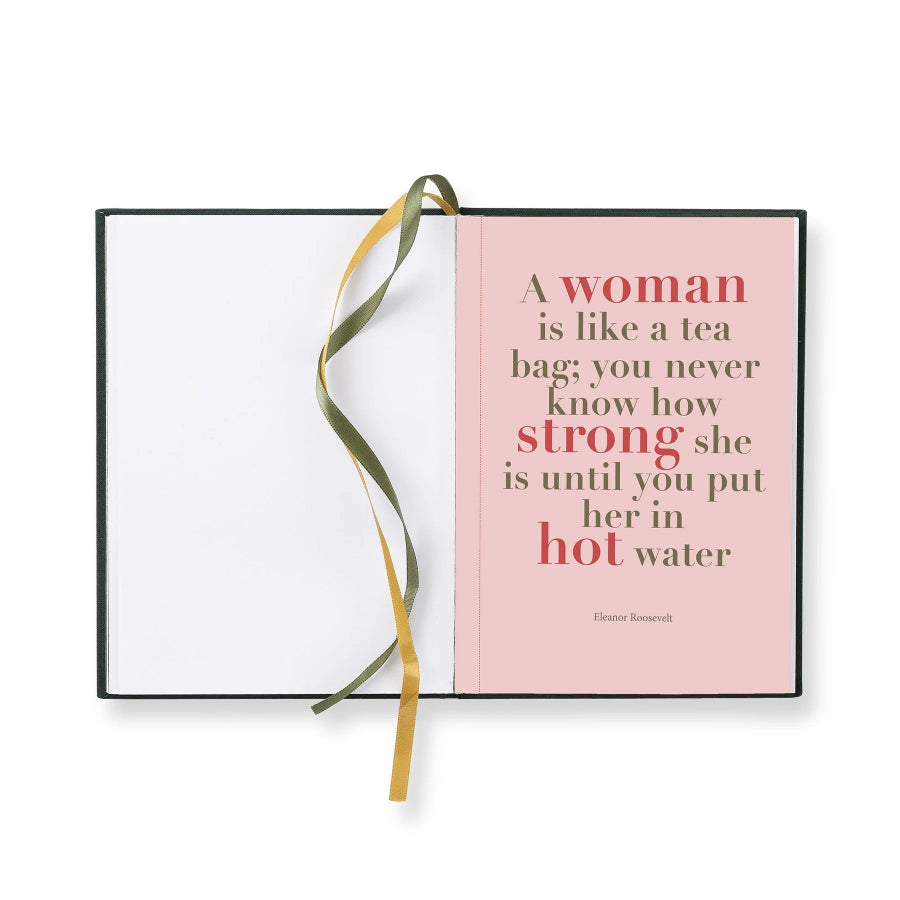 A square book or notebook with a black cover, shown open on a white background. The right page is pale pink with a printed quote in red and dark brown text, and a gold ribbon bookmark loops through the center.