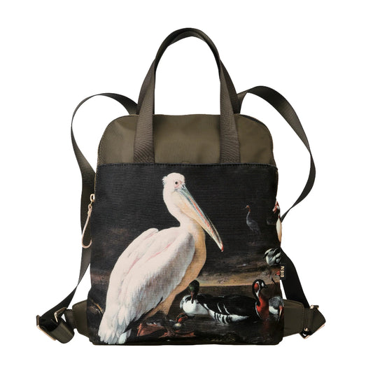 A structured canvas backpack featuring a detailed wildlife print of a white pelican and ducks on the front panel, with olive green fabric on the top and straps, set against a plain white background.
