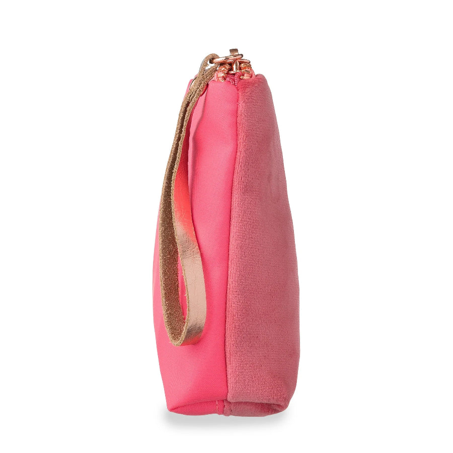 A bright pink drawstring pouch bag with a textured fabric body, a smooth pink side panel, and a tan leather wrist strap with rose gold metal hardware, shown on a white background.