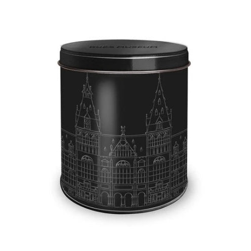 Black cylindrical tin with architectural design on a white background