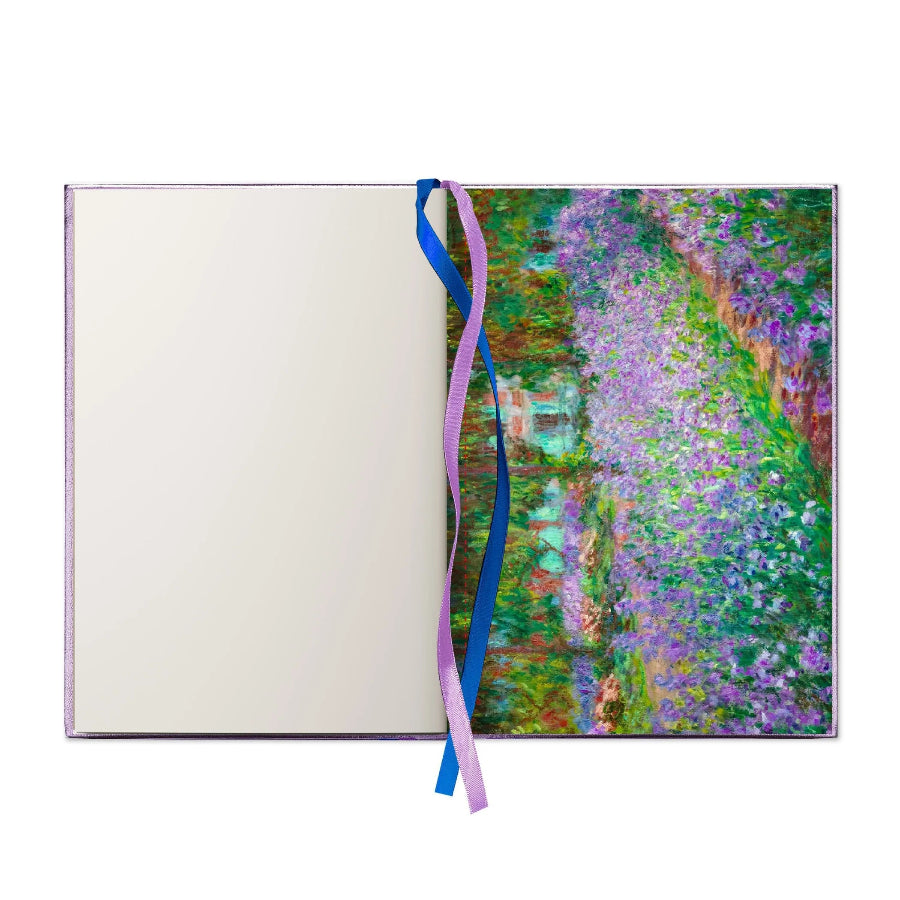 An open notebook or journal with a blank off-white left page and a right page featuring an impressionist floral landscape painting in purple, green, and blue tones. Two ribbon bookmarks, one blue and one lavender, hang from the center.