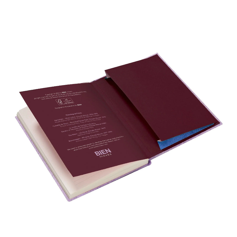 A burgundy open booklet or manual with printed text on the left page and a matching burgundy cover pocket on the right, shown on a plain white background.
