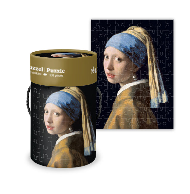 Jigsaw puzzle packaging with 'Girl with a Pearl Earring' artwork on a white background