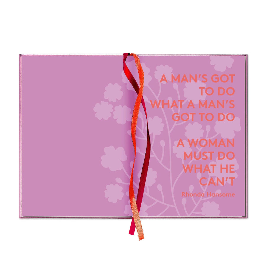 A pink rectangular book or notebook cover with a red ribbon tied vertically down the center. The cover features a light pink floral pattern and the quote 'A MAN'S GOT TO DO WHAT A MAN'S GOT TO DO / A WOMAN MUST DO WHAT HE CAN'T' by Rhonda Mansome in coral text.