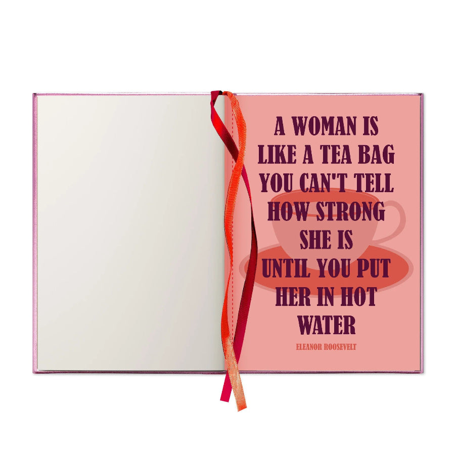 A pink book or notebook with a quote by Eleanor Roosevelt on the cover, featuring a red ribbon bookmark tied through the center, shown against a plain white background.