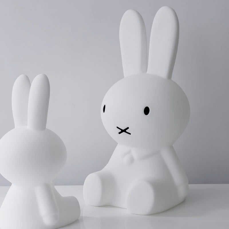 White rabbit-shaped lamp on a plain background