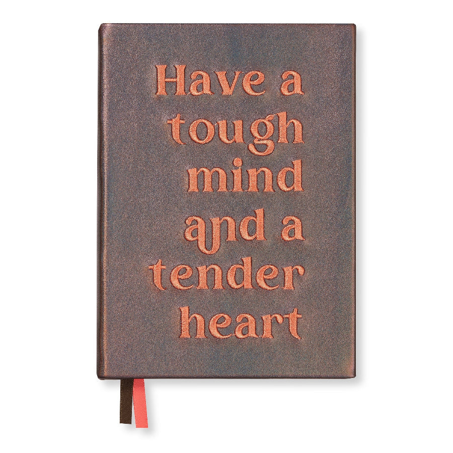A hardcover journal with a textured dark brown leather-like cover and raised peach-colored text that reads 'Have a tough mind and a tender heart.' A red ribbon bookmark and a black page marker are visible at the bottom.