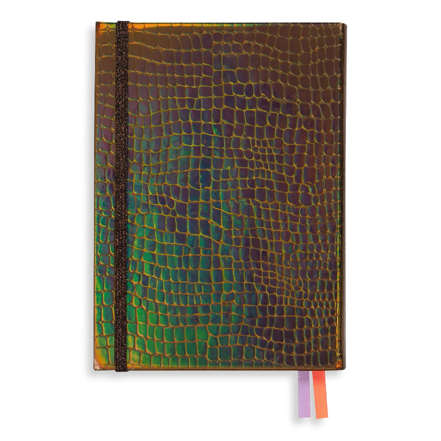 A hardcover notebook with a glossy, iridescent reptile-scale texture. The cover shifts between green, gold, bronze, and purple depending on the angle, secured with a black elastic band, and features two ribbon bookmarks in purple and orange on the right edge.