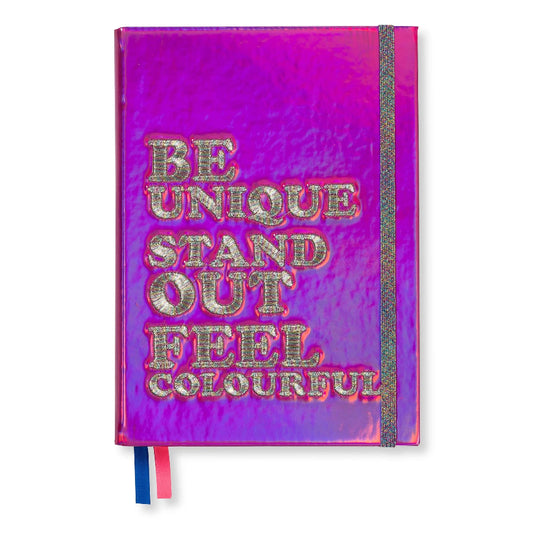 A hardcover notebook with a vibrant magenta and purple holographic cover. The front cover features the inspirational text 'BE UNIQUE STAND OUT FEEL COLOURFUL' in raised, glittery silver letters.